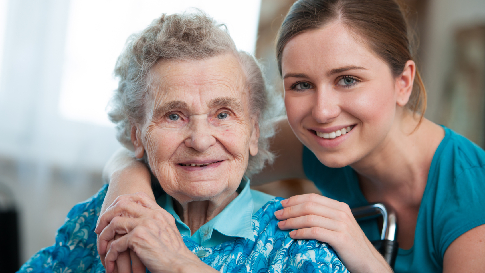 Senior woman with her caregiver at home